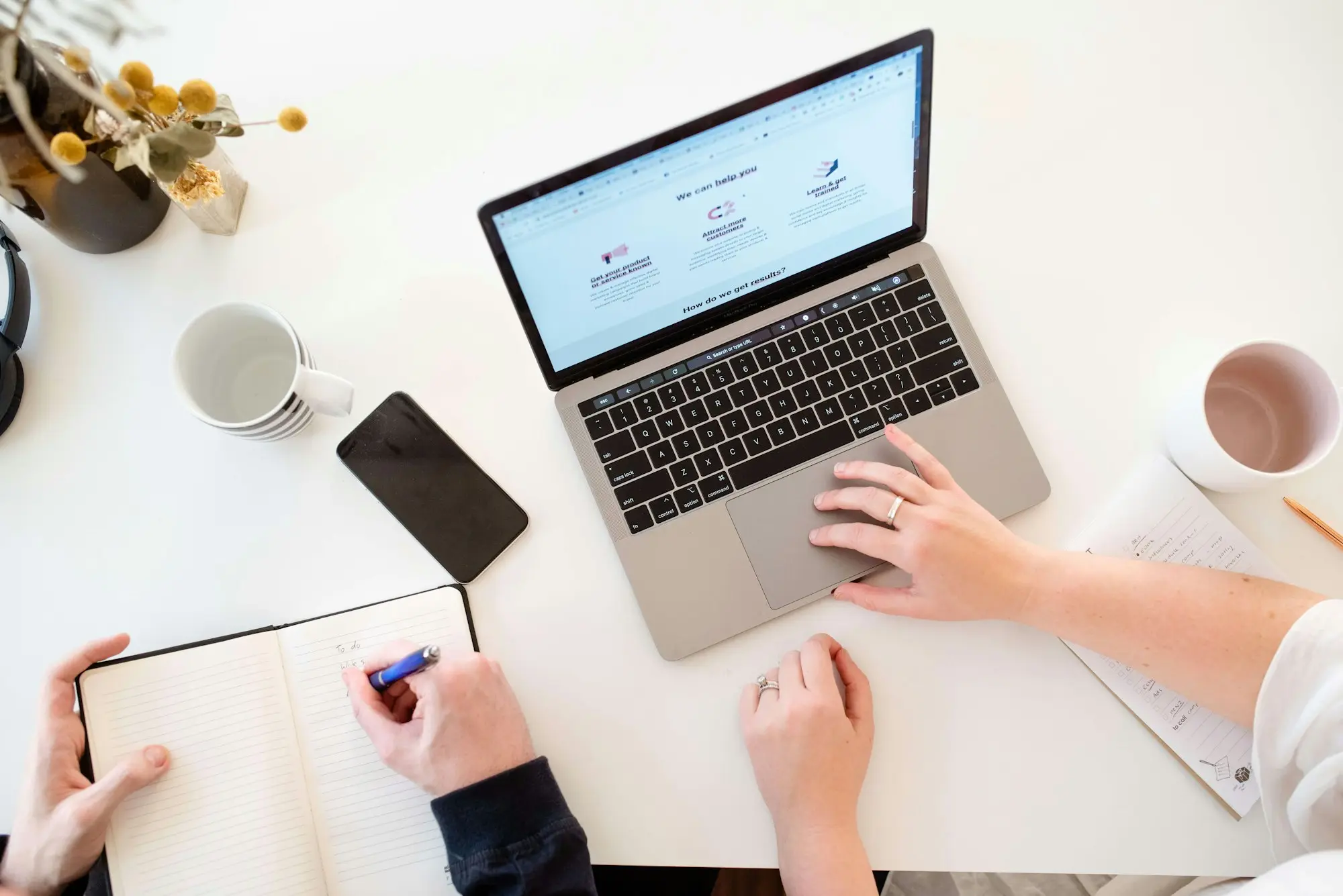 Business owner reviewing figures on a laptop at a kitchen bench in Canberra