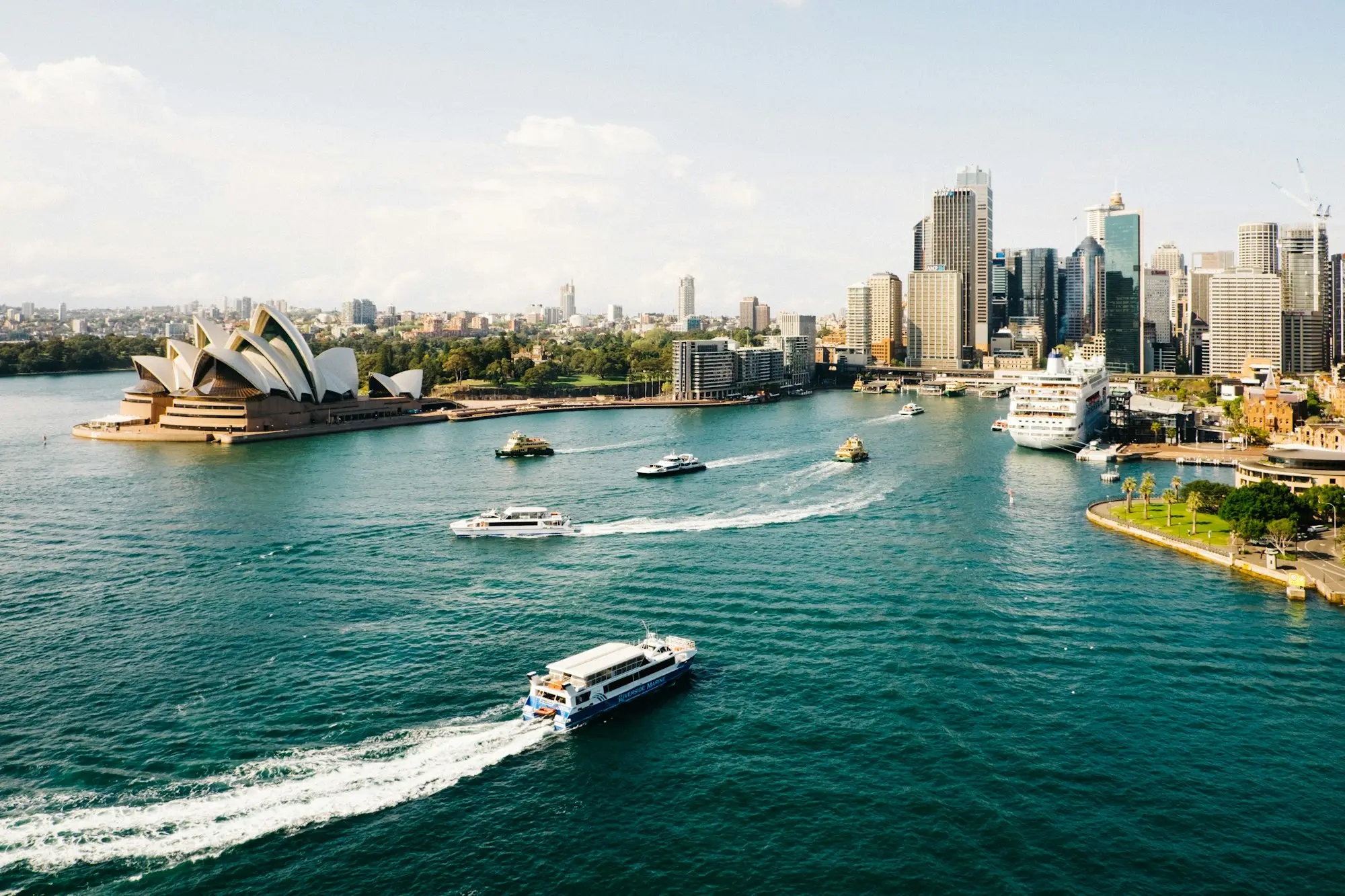 Sydney Harbour and CBD towers in early morning light with ferries on the water